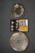 Two silver plated salvers, cased set of six fruit spoons and six fish knives and forks.