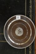 A silver circular equestrian presentation plate.