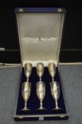 A cased set of nine Asprey & Co silver wine goblets, engraved with initials.