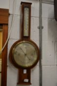 A mahogany cased barometer/thermometer.