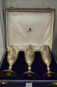 A cased set of Asprey & Co silver wine goblets, engraved with initials.