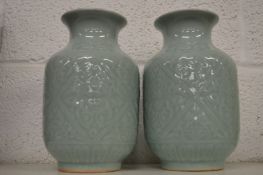 A pair of Chinese celadon glazed vases.