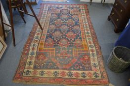 A Persian carpet, early 20th century, blue ground with stylised decoration, 260cm x 140cm.