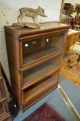 A Globe-Wernicke three section oak bookcase (one pane of glass missing).