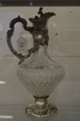 A good cut glass claret jug with embossed silver mounts.