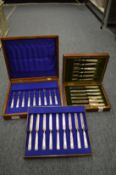 Two cased sets of silver dessert knives and forks with mother of pearl handles.
