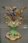 A large flower encrusted urn shaped vase.