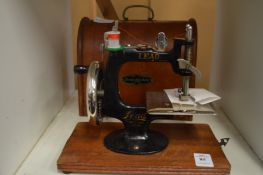 A Lead miniature sewing machine.