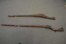 Two early matchlock rifles.