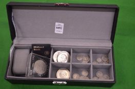 A jewellery box containing various coinage.