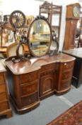 A Victorian mahogany dressing chest with oval mirror and an arrangement of drawers and a cupboard