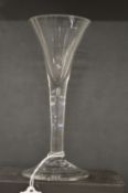 An 18th century English wine glass with tapering bowl.