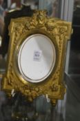 A gilt metal framed mirror.