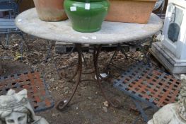 A faux marble circular patio table with wrought iron base.