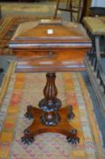 A 19th century rosewood teapoy of sarcophagus form.