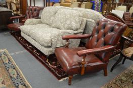 A good pair of red leather button upholstered open armchairs.