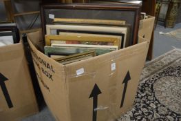 A box of assorted paintings and prints.