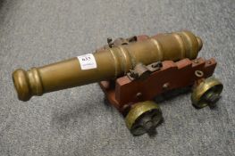 Model brass cannon with carriage.