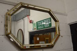 A decorative octagonal shaped mirror.