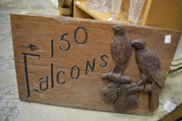 A carved wood house name sign.