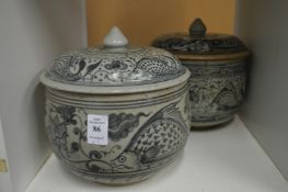 Two Oriental blue and white jars and covers.