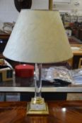 A brass and perspex lamp.