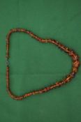 A good small amber graduated bead necklace.