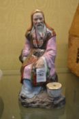 A Japanese satsuma seated figure.