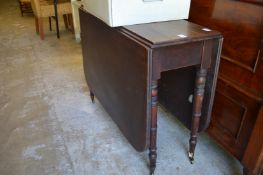 A 19th century mahogany drop leaf dining table.