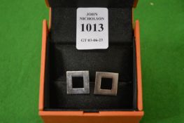 A pair of designer cuff links.