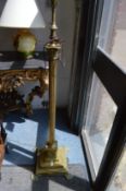 A brass corinthian column style floor standing lamp.