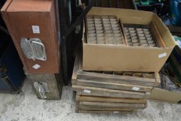 A quantity of old printers trays and two storage boxes.