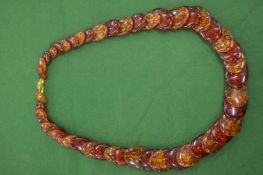 A large amber style necklace.