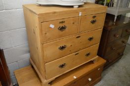 A small pine chest of drawers.