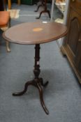 An inlaid mahogany tripod table.