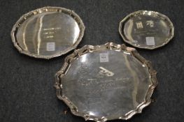Three silver salvers with engraved presentation inscriptions.