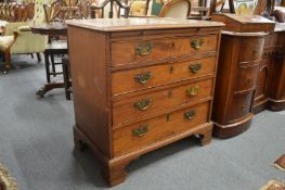 A George III mahogany small chest of drawers with brushing slide and four graduated long drawers