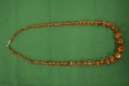 A good graduated amber moon shaped bead necklace.