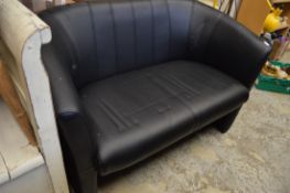 A small black leather cloth upholstered settee.