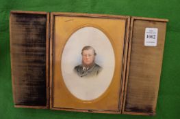 A leather cased miniature portrait bust of a bearded gentleman.