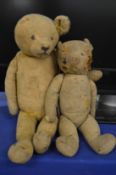 Two early, well loved teddy bears.