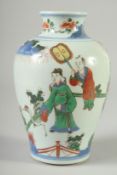 A CHINESE FAMILLE VERTE PORCELAIN VASE, painted with figures in a garden, 18cm high.