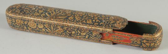 A 19TH CENTURY MUGHAL KALAMDAN PEN BOX, with gilded floral decoration, 24cm long.