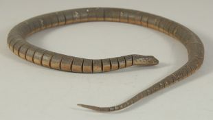 AN EASTERN CARVED AND HAND PAINTED ARTICULATED WOODEN SNAKE, 84cm long, in original fitted box.