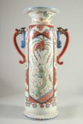 A LARGE IMPRESSIVE MONOCHROME PORCELAIN CYLINDRICAL TWIN HANDLE VASE, painted with a large panel