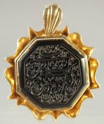 A FINE ISLAMIC CALLIGRAPHIC SEAL inset within a gilt metal pendant, 3.5cm x 3.5cm.