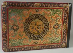 A LARGE QAJAR PAINTED WOODEN ALBUM COVER, the front and verso with central circular panel; one