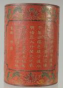 A CHINESE LACQUER BRUSH POT, with panels of incised characters, 15cm high.
