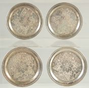 A SET OF THREE ISLAMIC ENGRAVED SILVER CIRCULAR COASTERS, 7cm diameter, weight 140g, (3).