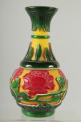 A CHINESE YELLOW, RED AND GREEN PEKING GLASS VASE, with raised flower heads and vine, 24cm high.